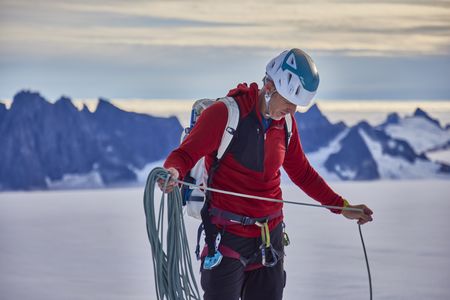 Tommy Caldwell preparing his climbing rope at the glacier camp at the base of the Devil's Thumb. (National Geographic/Pablo Durana)