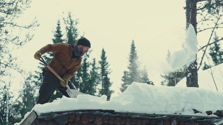 Billy shovels snow off of his roof. (Blue Ant Media/Tara Elwood)