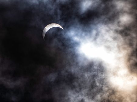 A total solar eclipse is observed through cloudy skies in Niagara Falls on April 8, 2024. (Credit: Cristina Mittermeier)