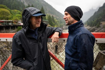 Sir Ranulph Fiennes and actor Joseph Fiennes stand on the bridge at Hell's Gate, as they revisit Ran’s 1971 expedition of Canada’s British Columbia. Amidst mountains and whale watching, Sir Ranulph Fiennes and his cousin Joseph Fiennes reflect on Ran’s epic life and his new challenge of life with Parkinson’s. (National Geographic)