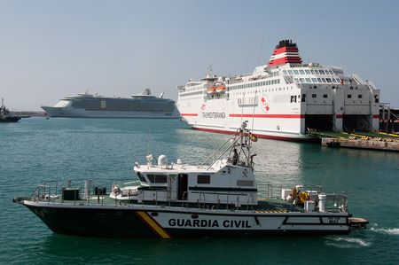 A patrol boat arrives at the dock, with cruise ships visible in the background in Tenerife, Canary Islands, Spain. (Guardia Civil)