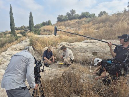 Crew members Ronen Mayo and Tamir Atli film as Ido Koch, Yuval Amir and Israa Shekh Yosef explore the Tel Hadid archaeological site in Megiddo, Israel. (Windfall Films/Nava Mizrahi)