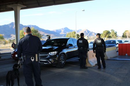 Multiple CBP officers overlook cars waiting in line in the pre-primary lanes at the El Paso border in El Paso, Texas. (National Geographic)