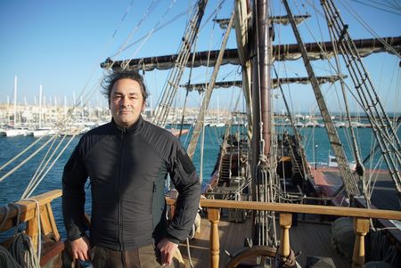 Claudio Lozano stands on the deck of a Puntales ship, standing by the wheel of the ship. The ship was used to defend against the french navy in the penninsular war in Spain. (National Geographic/Ciaran Henry)