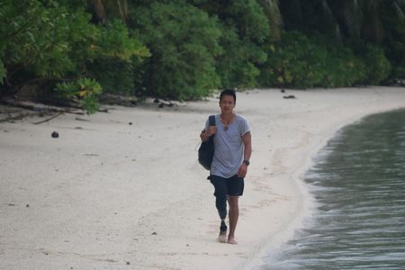 Dr. Albert Lin walks along the beach of Ant Atoll, Micronesia. (National Geographic/Blakeway Productions)
