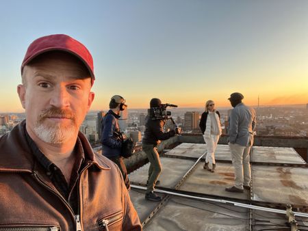 Crew film Mariana van Zeller and Ben on a rooftop in Johannesburg. (National Geographic for Disney)
