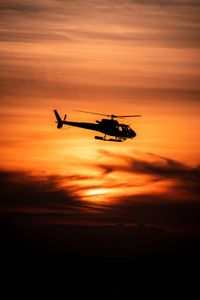 The OceanXplorer's helicopter flies at sunset. (National Geographic/Patrick Hopkins)