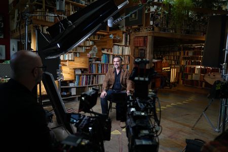 In this behind-the-scenes photo, French crime genre author Maxime Chattam gets ready to for an interview for "Killer Lies: Chasing a True Crime Con Man," a documentary series about obsession and deception, following the unraveling of Stephane Bourgoin’s career as a best-selling author and serial killer expert. (National Geographic/Ben Selkow)