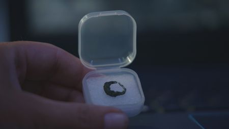 An earring found next to the skeletons that were discovered at the Mosul dig site in Mosul, Iraq. (Windfall Films/Ali Hilal Ali Hussain)