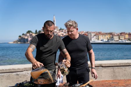 Croatia - Gordon Ramsay (R) stands by as Croatian chef David Skoko works on his spider crab and conger eel stew during the final cook. (Credit: National Geographic/Justin Mandel)