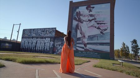 BLACK TRAVEL ACROSS AMERICA - Host Martinique Lewis (Marty) admires an installation at the Negro Leagues Baseball Museum in Kansas City, MO. (National Geographic for Disney)