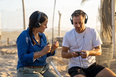 Liz Bonnin and turtle bioacoustics expert Dr. Gabriel Jorgewich-Cohen listen to olive ridley sea turtles vocalizing inside their eggs to synchronize hatching.  (National Geographic/Emilie Ehrhardt)