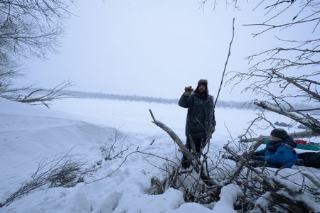 Chevie Roach teaches his son Ryder how to set marten traps along their trapline. (BBC Studios Reality Productions, LLC/Jayce Kolinski)