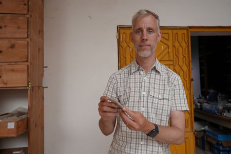 Henning Franzmeier examines items in the storeroom of Pi Ramesses in Egypt. (Windfall Films)