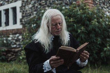 John Lowes, an accused clergyman, sits and read a book. (Dash Productions Services LTD/Antoan Ivanov)