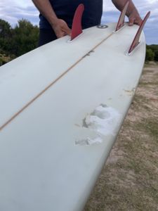 Shark bite mark on Stuart Anderson's surfboard. (National Geographic/Robert Cowling)