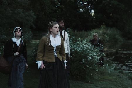 Mary Dunbar walks with two villagers. Janet Main observes them from the background. (Dash Productions Services LTD/Antoan Ivanov)