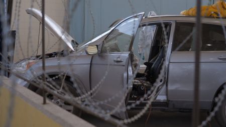 A suspect's vehicle is being dismantled after packages of suspected narcotics were discovered smuggled inside the center console. (National Geographic)