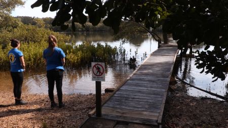 Kelsey and Hayley the vet nurse watching the pelican swim away. (EQ Media Group/Jackie Munro)