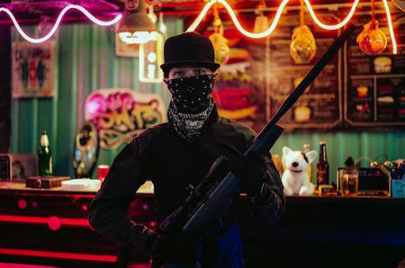 A masked man holding a rifle. (National Geographic)