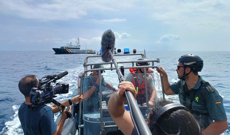 The film crew captures footage in a behind-the-scenes image on board a Civil Guard patrol boat in Ibiza, Balearic Islands, Spain. (National Geographic/Jose Antonio Gavilán Tobal)