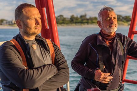 Cinematographer, Rory McGuinness, and camera assistant, Woody Spark, on board a dive vessel in Port Phillip Bay.  (photo credit: National Geographic/Harriet Spark)