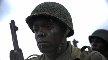 Private Henry Parham (played by Ishmel Bridgeman) awaits his turn to land on Omaha Beach in a scene of a WW2 historic reenactment production for "Erased: WW2's Heroes of Color." Private Parham served with the 320th Barrage Balloon Battalion on D-Day. (National Geographic)