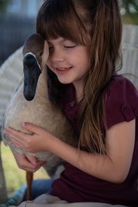 A goose being hugged by a child. (Big Wave Productions)