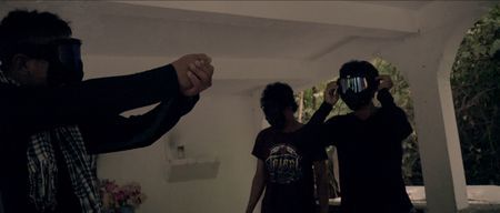 Philippines - Bato demonstrates to two members of his group how to take aim. (Genius Loki Film and Violet Films/Alexander A. Mora)