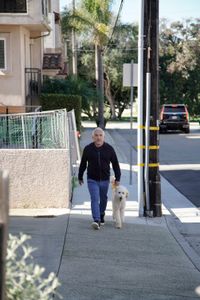 Cesar approaches Alex and Thomas' residence with a new dog. (National Geographic)