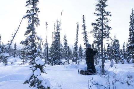 Johnny Rolfe checks his traps while successfully catching a rabbit during the winter season. (BBC Studios Reality Productions, LLC/Tyler Colgan)