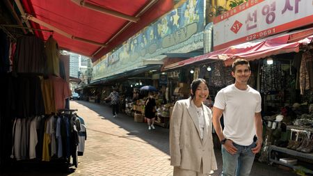 Awkwafina and Antoni Porowski walk through a market in Daegu. (National Geographic/Rebecca Eishow)