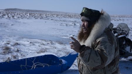 John Pingayak collects firewood on the frozen tundra. (National Geographic/Matt Kynoch)