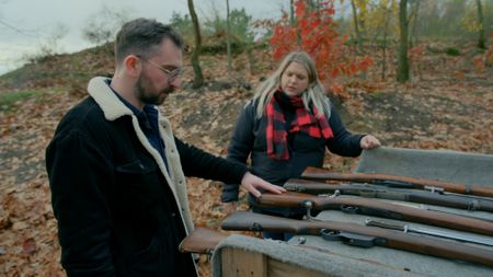 Contributor on left, Alina on right looking at guns. (National Geographic)