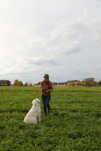 Beth Pol continues to train Clovis, the Pol family's new dog, to stay, while at the Pol family's farm. (National Geographic)