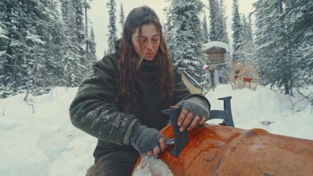 Margot contructs a new stove from an old barrel. (Blue Ant Media/Tara Elwood)