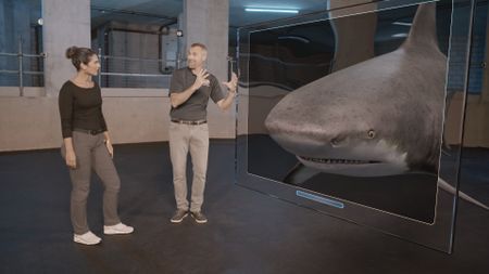 Dr. Diva Amon and Dr. Mike Heithaus looking at the features of a GFX Bull Shark whilst being in the shark studio lab. (National Geographic)