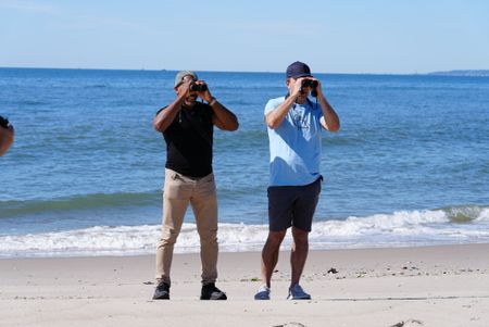 Christian Cooper and NYC Plover Project founder Chris Allieri look at a piping plover through binoculars at Fort Tilden. (National Geographic/Troy Christopher)