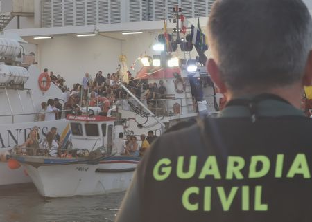 Fishing boats are crowded with people during a Virgin of El Carmen celebration in Barbate, Cadiz. Spain.(National Geographic/Jose Antonio Gavilán Tobal)