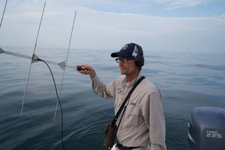 Capt. Greg Metzger uses a VHF receiver on the boat, as the team desperately try to get a signal from Liberty's tag. (National Geographic/Brandon Sargeant)