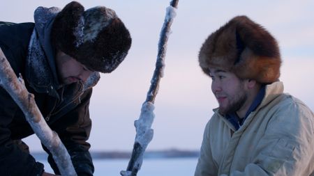 Gage and Avery Hoffman a fish net under the ice. (BBC Studios/Danny Day)