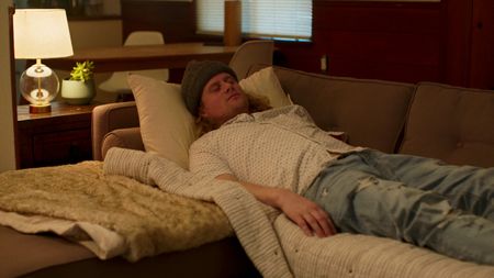 Matt lies on a couch after taking LSD for a psychedelic therapy session. (National Geographic)