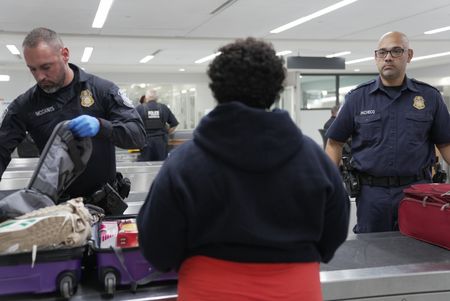 CBP Officer Mccants questions a passenger while going through their belongings in Atlanta, Ga. (National Geographic)