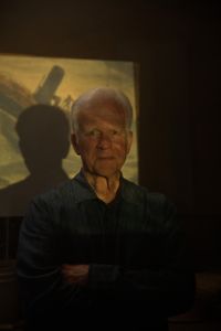 Gary Kinder, author of "Ship of Gold in the Deep Blue Sea," poses for a portrait in front of a projection during the production of "Cursed Gold: A Shipwreck Scandal." In 1989, maverick scientist Tommy Thompson stuns the world by recovering three tons of gold from a shipwreck deep in the Atlantic Ocean. What follows is a 30-year story of adventure, deception, and personal turmoil, taking him from venerated celebrity to infamous fugitive, and finally a defiant prisoner who refuses to give up his gold. (National Geographic)