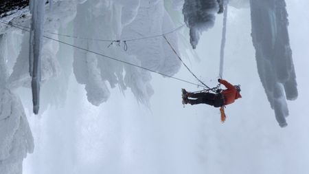 Will Gadd knocks ice off a rope while climbing Helmcken Falls.  (mandatory credit: Red Bull Media House)