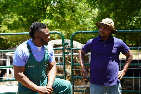 Dr. Hodges and LeMario Brown have a discussion about the health of the goat herd. (National Geographic for Disney/Nicholas Reaves)