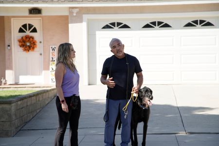 Cesar Millan standing with Lloyd while talking to Jaclyn. (National Geographic)