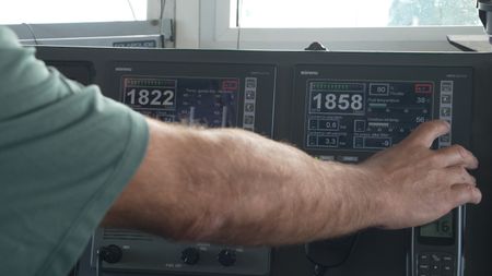 A Guard uses the dashboard of a maritime patrol vessel in Cadiz, Spain. (National Geographic)