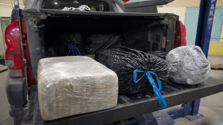 Multiple large packages of suspected narcotics are seen in the trunk of a suspect's after being discovered by CBP in the car.  in El Paso, Texas. (National Geographic)