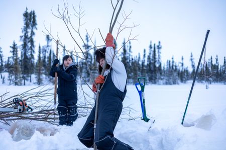 Ricko DeWilde teaches his son Keenan DeWilde how to properly set a beaver trap under the ice. (BBC Studios Reality Productions/v)